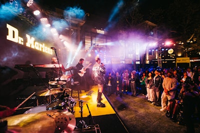 An elevated stage and lighting theatrics set the scene for performances from R&B singer Tinashe and DJ Andre Powers. 'The yellow stage created an anchor to the party and hosted the two acts throughout the night—a real beacon of light in the setting of The Grove!' said Pavlik. 'Design-wise, we again infused that Doc’s yellow in various ways, and expanded with multimedia imagery on a giant LED.'