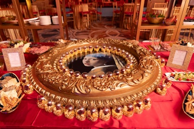 An artful platter featuring Vermeer’s “Girl with a Pearl Earring” was bordered with mini Eternal rose vases filled with cheese and charcuterie.
