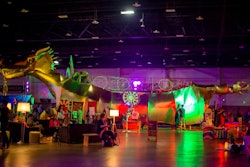 A gold Burning Man dragon installation was a focal point in the roomy 'Deep Space' exhibition. Speakers, performers, and artists utilized the surrounding space for engaging conversations.