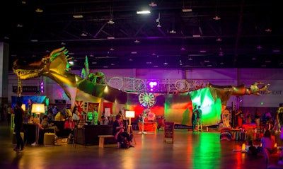 A gold Burning Man dragon installation was a focal point in the roomy 'Deep Space' exhibition. Speakers, performers, and artists utilized the surrounding space for engaging conversations.