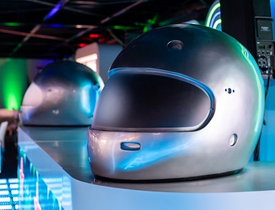 The neon-inspired space made an impact with oversize driver helmets as decor.