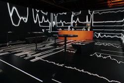Bulleit Frontier Whiskey debuted the Bulleit Limitless Lounge on Nov. 7. The multisensory, immersive bar in Downtown LA blends art, design, cocktails, music, and projection mapping technology to create a physical space where the walls, furniture, and floors change from one scene to another while guests enjoy their drinks. Bulleit partnered with the immersive media artists at Optical Animal to create four designs centered on nature, art, music, and imagination; the music theme (pictured), for example, begins as a single bouncing thread that wraps the room, reacting to the sounds of artist Bronze Whale’s track “Good Enough.” As the track builds, the room transforms into a colorful variety of audio visualizations that react to the music.