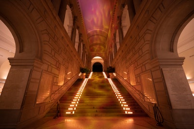 As soon as guests entered the Met’s Great Hall, they were immersed in the world of Percy Jackson’s Camp Half-Blood—the training camp in the novel-turned-TV series where demigod children receive protection and training to hone their unique skills—'via orange-hued lighting, props and projections, and a harpist,' Nelson explained.