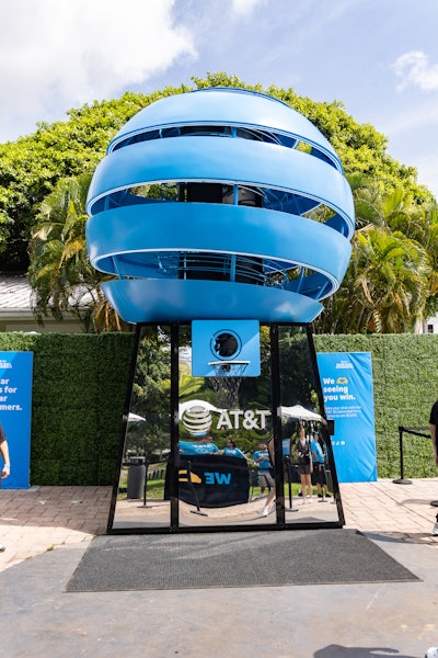 AT&T, in partnership with the NBA, enlisted actress Issa Rae to show appreciation for its customers ahead of the NBA Playoffs in April 2023. The pop-up—a 20-foot gumball-inspired experience at The Grove in Los Angeles—gave AT&T customers the chance to win tickets to the NBA conference finals along with other prizes, including signed NBA player basketballs, Google Pixel devices, and more. (Winners of the AT&T 5G-branded basketballs won a whopping $5,000.) AT&T customers scanned a QR code from their phones, releasing a color-coded basketball that correlated with a certain prize category.