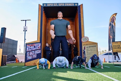 To celebrate the new season of its original series Reacher, Prime Video brought a 15-foot action figure of the title character to Las Vegas' Allegiant Stadium during Thursday Night Football Dec. 14. The activation space, located just outside the stadium, also featured a live performance from DJ PZB, photo ops, prizes, and more. There were also Reacher-inspired challenges, including a pushup contest and the chance to decode a puzzle inspired by the new season; fans who completed the challenges unlocked exclusive prizes like signed books, meal gift cards, car decals, and more. Prime Video worked with Little Cinema on the stunt.
