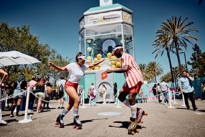 YouTube offered two activations for consumers outside the convention center at VidCon in 2022, both produced by MAS. One was a playful take on a drive-thru experience for YouTube Shorts, where guests stepped onto an amusement-style ride via tricked-out golf carts that took them on a journey to learn about YouTube Shorts, shoot a short in real time, and beat the heat with a refreshing iced slushie. But the second activation was the real showstopper: a 40-foot-tall gumball machine to promote popular YouTuber MrBeast and his Feastables products of snacks. Fans were able to insert a larger-than-life gold coin, crank the machine up, and watch as a huge, bright yellow gumball rolled down the chute.