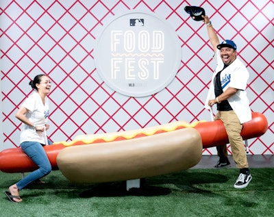 The MLB FoodFest took place in Los Angeles in 2019, offering activities such as the oversize 'Weiner-totter.' MKG produced the event.