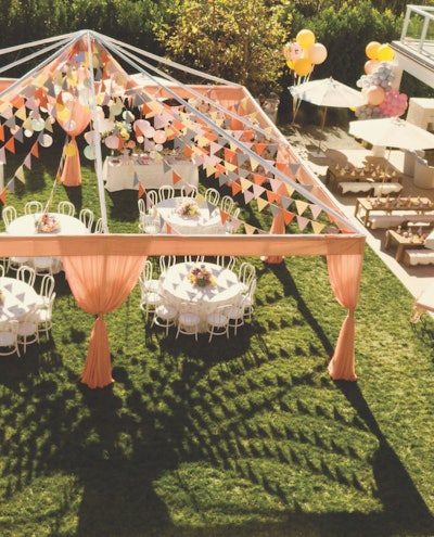 This outdoor tea party-themed gathering featured an open-air tent structure with peach-colored draping by Los Angeles-based Town & Country Event Rentals.