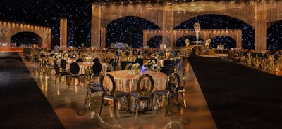 The black and white palette was highlighted by splashes of Emmy-inspired gold, including 250 linear feet of gold chain curtains that cascaded from two stories above the floor. At the apex of the room, a massive Emmy statuette reached 24 feet above the guests; it was accompanied by four nine-foot versions positioned on a central, tiered platform. A 40-foot-diameter carpet at the base of the Emmy centerpiece was a custom-made black and white pinwheel. 'Our goal was to mark this amazing milestone of Emmy’s 75th anniversary with a historic celebration bringing the industry together in recognition of the tens of thousands of people who play key roles in telling great stories that enthrall international audiences,' said Television Academy President and CEO Maury McIntyre in a press release.