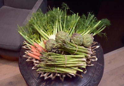 For the July 2018 launch of Farmacy Kitchen Cookbook, which focuses on plant-based eating and conscious living, The James Group designed an event in West Hollywood that was inspired by the book's focus on fresh, locally sourced vegetables. The team decided to incorporate vegetables as decor throughout the entire event, like in these centerpieces made from bunches of asparagus, artichokes, and carrots. See more: 4 Helpful Design Tips for Using Vegetables as Event Decor