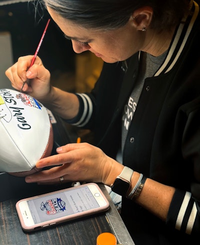 Lettering and logo artist Lauren Nisenson personalized the CFP footballs for guests.