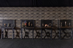 A display case of Society Awards' work includes the MTV Moon Person, Inkpot Award, and the David Yurman Muse Award.