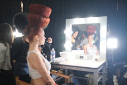 The event featured a hair show with artistic styles inspired by the product packaging, a product display, and an ingredient bar.
