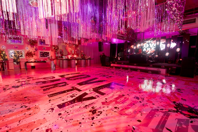Of course, the centerpiece of the LOVE Party was a dance floor that boasted the event’s paint-splattered and lipstick-kissed branding. Amid dancing the night away, eventgoers could quench their thirst at one of multiple bars, where liquor bottles shared shelf space with the amount of red roses lovers dream about receiving on Valentine’s Day.