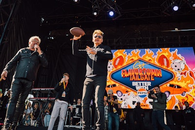 During the tailgate, Fieri took on Eli Manning in a football-throwing contest and threw signed footballs into the crowd. Other celebs also partook in the tailgate experience, including Gordon Ramsay, who joined Fieri onstage.
