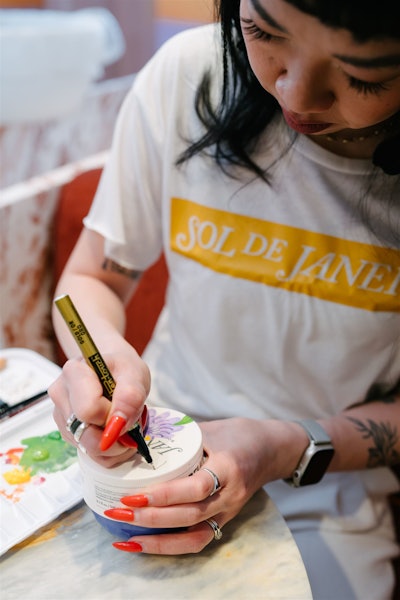 An artist was on hand painting custom designs on products.