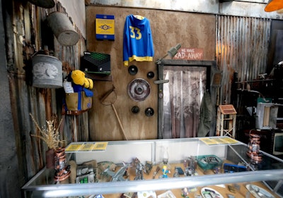 The alfresco space had a tunnel entrance, actors playing town people, and built-out areas of exploration like the dentist’s office or the sundries shop. The decor leaned into the post-apocalyptic theme with rusted tin, dried floral arrangements, draped netting, and a retro television at the bar.