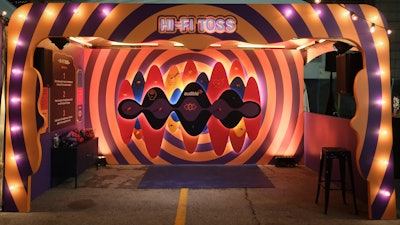 On the ground level, attendees could play various carnival games that highlighted Audible genres. After collecting stamps on a card, they were able to redeem it for prizes such as apparel or Fire Sticks. There was also a listening wall with headphones set up so that people could listen to various shows.