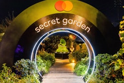 Another event that played with curves and circular shapes was the Recording Academy's Grammy House, where guests could stroll through a lush green setting full of real living plants, trees, and ivy. A circular tunnel, evoking sponsor Mastercard's logo, was used as a transition moment and to frame an oversize gramophone, whose gold exterior had been swapped for living moss.