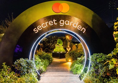 Another event that played with curves and circular shapes was the Recording Academy's Grammy House, where guests could stroll through a lush green setting full of real living plants, trees, and ivy. A circular tunnel, evoking sponsor Mastercard's logo, was used as a transition moment and to frame an oversize gramophone, whose gold exterior had been swapped for living moss.