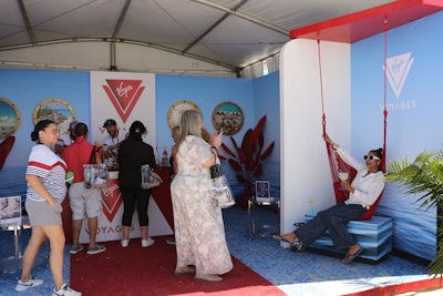 Virgin Voyages attracted guests with the signature red hammock from its cabin balconies—popular for photo ops—and poured drinks inspired by onboard menu offerings in a booth outfitted with portholes to notable destinations. Additionally, the adults-only cruise line added promotional flyers to every ticketholder's official gift bag with an exclusive SOBEWFF trip promotional price and ship credit for guests who booked during the festival dates.