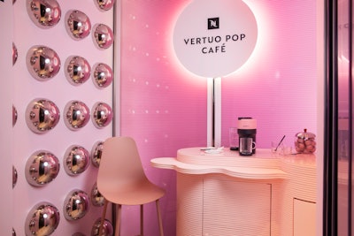 The design of the elevator cafe space was inspired by the Pop machine itself, including the pink color scheme and wall decor featuring reflective spheres based on the Vertuo capsules used to brew coffee. The space was developed with experiential partners Invisible North. The campaign includes organic and paid social, as well as a partnership with Architectural Digest, which helped consult on the cafe’s design elements. In August, Nespresso and nmbl launched the first Vertuo Pop Café by transforming gondolas on the Santa Monica Pier Ferris wheel into mini cafes, featuring trained baristas serving iced coffee.