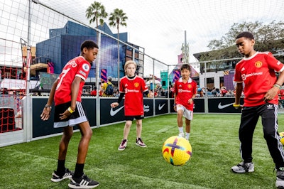 In January 2023, Universal CityWalk in Orlando was home to a Premier League Mornings Live fan fest for two days, celebrating fans of world-class soccer. Throughout the event, more than 9,600 fans of all ages enjoyed eight massive LED screens for live match viewing, plus on-site consumer activations, talent meet-and-greets, player visits, free merchandise, and more. The Premier League fan fest events are purposely kept family-friendly, the organizers told BizBash—noting that several experiential offerings were particularly popular with younger fans, like photo ops with the Premier League club mascots and the Premier League trophy, EA Sports-sponsored gaming stations featuring FIFA 23, airbrush tattoos, and a football pitch sponsored by Nike (pictured). See more: How NBC Sports and Premier League Hosted a Huge Fan Event Inside a Theme Park
