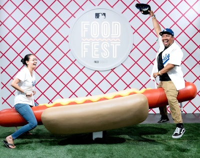 The MLB FoodFest took place in Los Angeles in 2019, offering activities such as the oversize 'Weiner-totter.' MKG produced the event, which gave fans of all ages the opportunity to taste special menu items from all 30 ballparks in one indoor space.