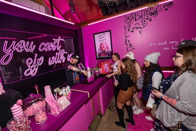 The two-level space featured areas dedicated to various programs from the subscription service, such as the vibrant pink speakeasy bar with a specialty cocktail, candy, and a book prop from the new Mean Girls film. There was also a sports bar with games and displayed jerseys, plus a ski lift per the theme.