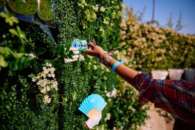 ORBIT Gum offered attendees refreshing surprises at its 'wall of Enchant-Mint,' where hands reached through a hedge to give out gum, branded fans, and more.