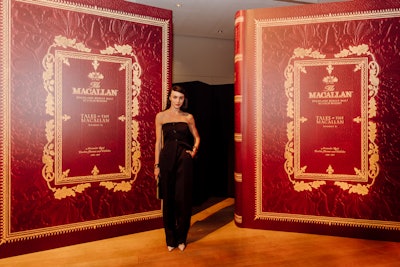 The Trust’s Willem Marx hosted the evening, which included a fireside discussion between The Macallan brand ambassador Molly Melville and Sunday Times columnist Will Lyons. Later, Melville dramatically unveiled a custom display case housing The Macallan’s newest limited-edition release, Tales of the Macallan Volume II. (Only 300 bottles were produced globally, valued at $100,000 each, encased in a Lalique crystal decanter, and inset within a substantial handcrafted 800-page book.) Afterward, attendees were invited to participate in a special whisky tasting and pose for photos in front of 9-foot replicas of the Volume II book (pictured).