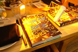 Guests were welcomed to their seats with a book decorated with a reading light that illuminated the place cards and added an amber glow to the tablescape.