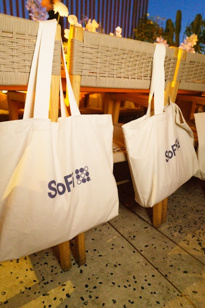 Attendees were gifted a swag bag that included a copy of the book and SoFi-branded goodies such as a tote bag, a Stanley Cup, an Alo sweatshirt, and a metal bookmark.