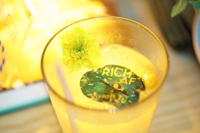 To kick off the evening, guests were treated with a welcome cocktail decorated with Rich AF book cover drink accessories. Guests enjoyed a five-course meal and a cake version of Rich AF along with affogatos embellished with the SoFi logo. Event planning and publicity was handled by The Brand Guild. Florals were provided by Nonsense Florals, and the book centerpieces were by Book and Timbers.