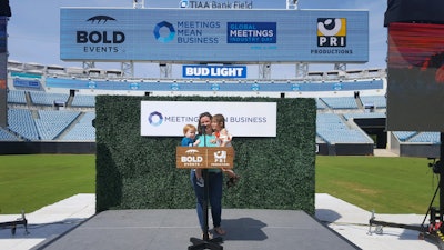 Dean pictured with her children on Global Meetings Industry Day in 2019, where she served as the event's co-chair.