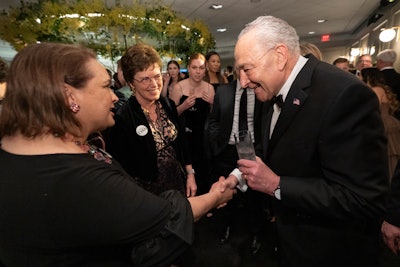 Guests, like Sen. Chuck Schumer pictured here, could enjoy music by Les the DJ. Scenic and AV was provided by Legacy Scenic and 4Wall.