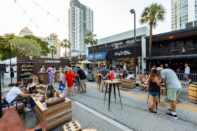 Park City, Utah’s High West Distillery invited guests to a whiskey lounge with Western mountain vibes. The build-out included a wood-paneled bar serving whiskey cocktails, along with matching wooden lounge furniture and high-top tables, as well as a live band for entertainment.