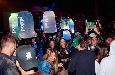 TAO Group Hospitality also integrated the brand into a variety of other touchpoints, including a signature “poppi citrus spritz” cocktail, product integration at VIP tables, and a poppi parade (pictured).