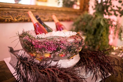 For a vendor showcase in Los Angeles, Patina Catering used elements like flowers, moss, and branches to bring to life a “living garden” theme. Champagne chilled in bowls reminiscent of birds' nests, made from foraged organic materials.