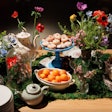 New York-based company Mary Giuliani Catering & Events draws on its founder's theater background to tell stories through food, like with this lush, floral-filled food display that incorporated a pretty spring-inspired tea set.