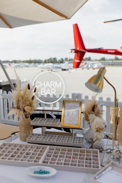 Jay's Catering tapped Parker J Permanent Jewelry where guests could get precious-metal permanent jewelry and peruse this charm bar.