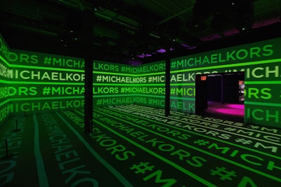 On the eve of New York Fashion Week in 2019, a digitally led experiential event celebrated the launch of the new MICHAEL Michael Kors spring 2019 campaign starring Bella Hadid. Spread across multiple exhibit spaces, the event immersed guests in the brand's curated videos, images, and music using Dolby audio and visual technologies. As guests walked in, they entered the 'Infinity Space': a 360-projected environment featuring bright, graphic treatments of the Michael Kors charm displayed on an infinite wall of Dolby Vision-enabled televisions. The room alternated a series of logo-laden video images akin to a nightclub for a truly immersive and interactive experience while guests could capture their experiences via Hypno BODY cameras. See more: See Michael Kors's High-Tech Take on the Jet Set