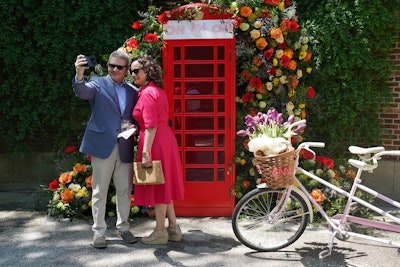 Guests were greeted with freshly chilled juice shots upon arrival, plus modern takes on Pimm's Cups and palomas while posing in front of a floral-walled phone booth.