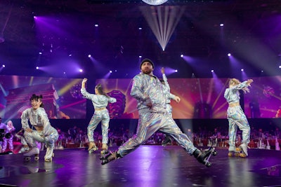 A troupe of roller-skaters escorted the 3,000 guests in attendance from the cocktail hour area into the reception space.