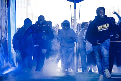 Fans walked through a replication of Ford Field’s graffitied tunnel out onto a small-scale football field, complete with fog machines, an announcer, and a video board livestreaming each walkout—just like the players’ entrances during Lions home games.