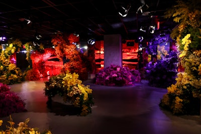 Mirrored columns adorned with cascading florals act as a guide, creating a path from the physical to the immersive digital floral experience.