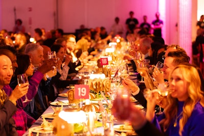 Adrienne Elise Tarver's painting “Dark Star” inspired the decor for the party, immersing attendees in vibrant sunset hues. The painting was also featured as part of the tropical dinner tablescape.