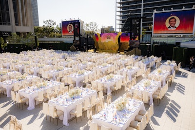 In the seated dinner area, the main stage was adorned with leaf-and-branch-shaped gold structures, inspired by water and air and symbolizing growth. Birds “in flight” added to the composition, and dinner tables were adorned with white roses and orchids. Dignitaries and A100 honorees—including Padma Lakshmi, Saweetie, Steven Yeun, and Lucy Liu—took the stage while the gala's 660 guests enjoyed dishes curated by Lakshmi and chef Vijay Kumar of Semma in New York. The three-course dinner highlighted Asian Pacific flavors and showcased some of Lakshmi’s cherished family recipes. A performance by Saweetie closed the show before guests headed to a lively after-party presented by Gold House and Billboard, which showcased cuisine by Panda Express and a boba bar by Bopomofo. Performers included A100 honoree Steve Aoki and RuPaul's Drag Race winner Nymphia Wind.
