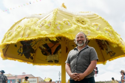 Expedia's art installation at the 2024 New Orleans Jazz & Heritage Festival was a larger-than-life parasol in a nod to the event's logo, created in partnership with local Colombian artist Basqo Bim (pictured).