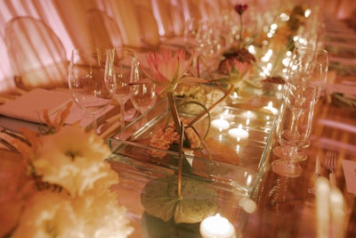 'The table centerpieces were water-filled mini vignettes of different pond florals including floating lily pads and blossoming chrysanthemums,' added Chan. 'The glass table and mirrored flooring created mesmerizing reflections enhancing the illusion of being underwater.'